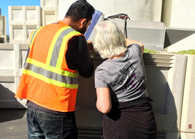 Head Winemaker, Manveer Sandhu and Executive Director of Winemaking, Penny Gadd-Coster, checking Chardonnay grapes in a harvest bin for quality control.