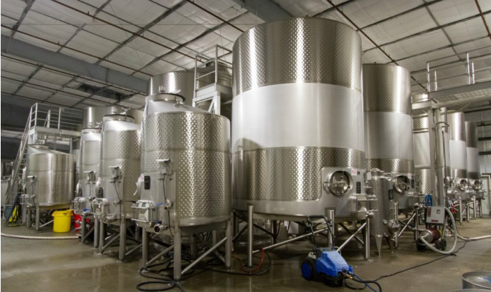 View of temperature controlled stainless tanks at our facilities. Temperature controlled stainless tanks clustered together at our Healdsburg, California location wine cellar.