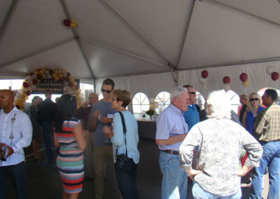Denise Lundquist (Wife of Bruce Lundquist) and Penny Gadd-Coster talking with guests at the Grand Opening event in 2014