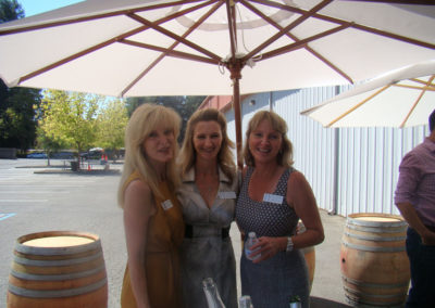 Sisters Sharon Cohn, Cynthia Faust and Rebecca Faust posing together while celebrating the Grand Opening of Rack & Riddle Healdsburg.
