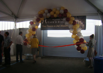 The threshold ribbon at the Grand Opening celebration party in 2014 in Healdsburg being strung up by Healdsburg Chamber employees.