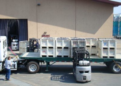 Harvest grapes arriving on a truck and a fork lift greeting the truck and removing the bins.