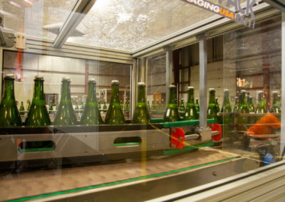 Bottles on tirage bottling production line for sparkling wine.